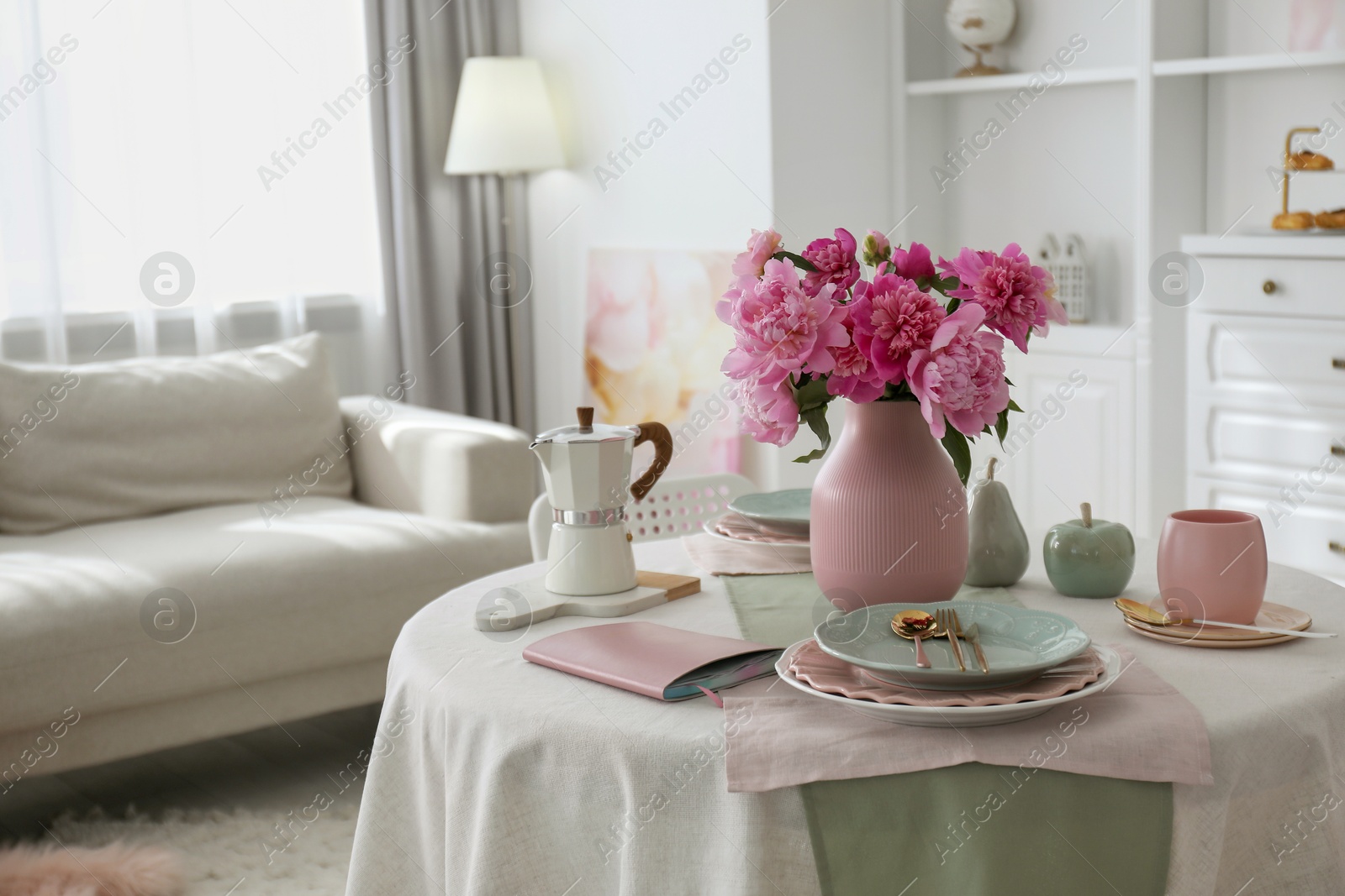 Photo of Beautiful table setting with pink peonies in living room. Space for text