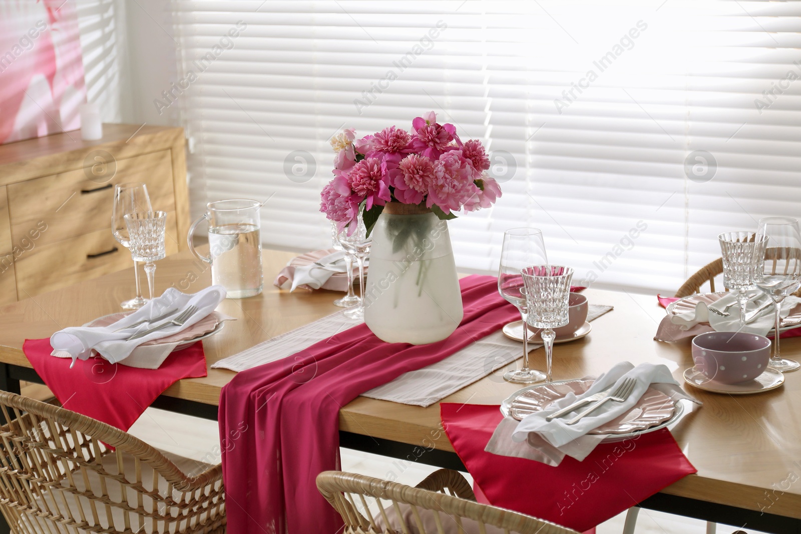 Photo of Beautiful table setting with pink peonies in dining room