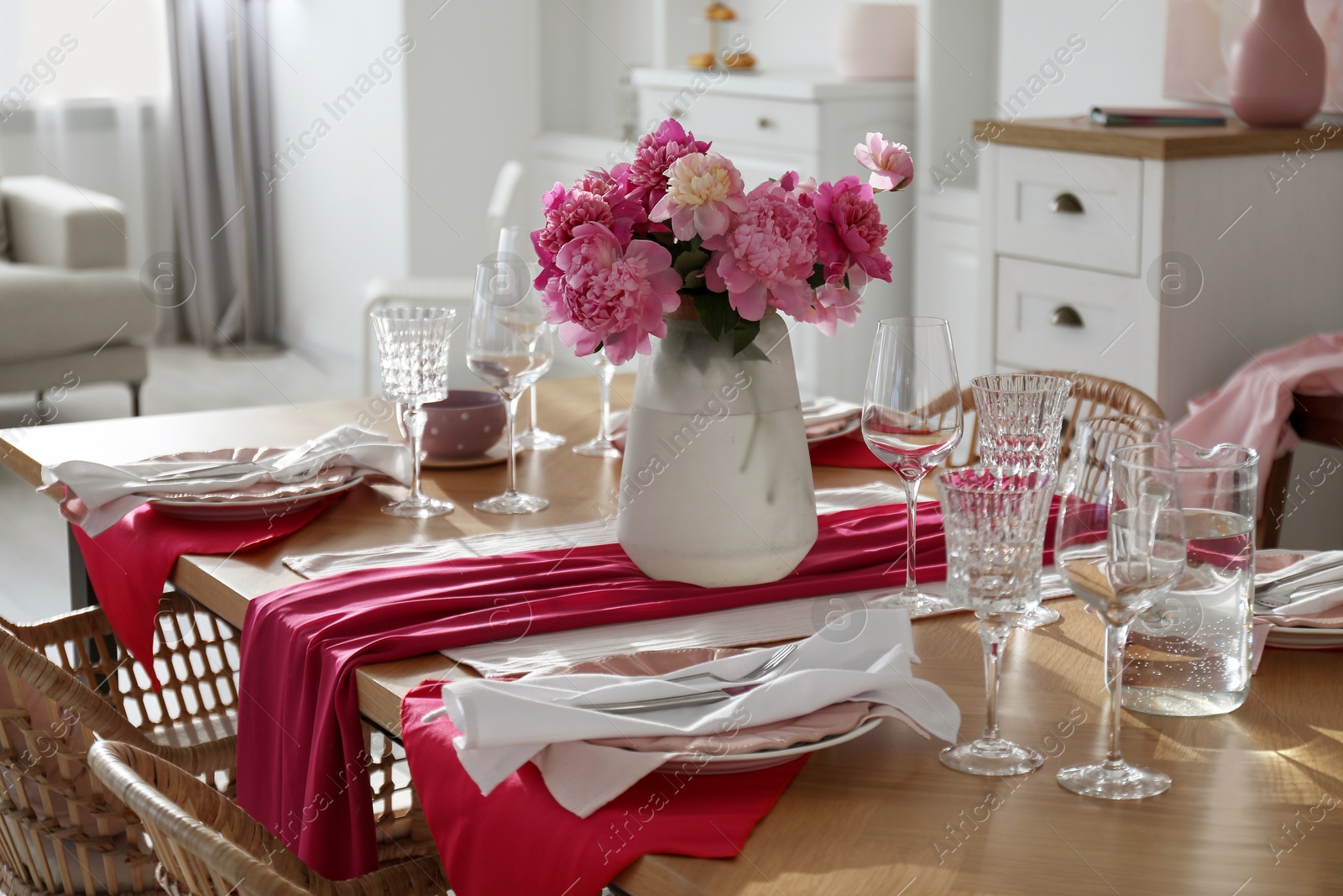 Photo of Beautiful table setting with pink peonies in dining room