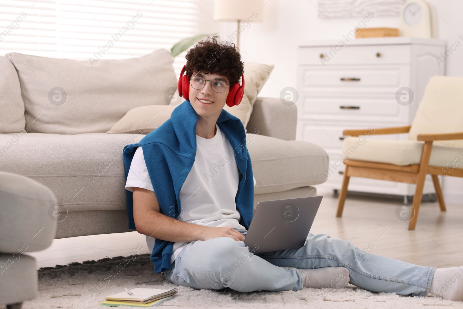 Photo of Teenager in headphones having video chat via laptop at home. Remote work