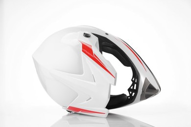 Photo of New stylish motorcycle helmet on white background