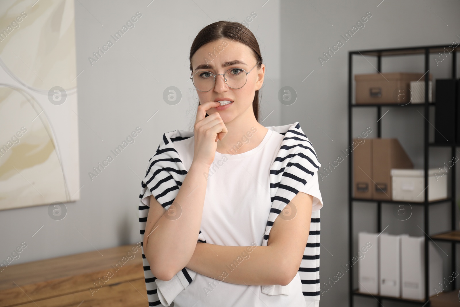 Photo of Portrait of embarrassed woman in glasses in office