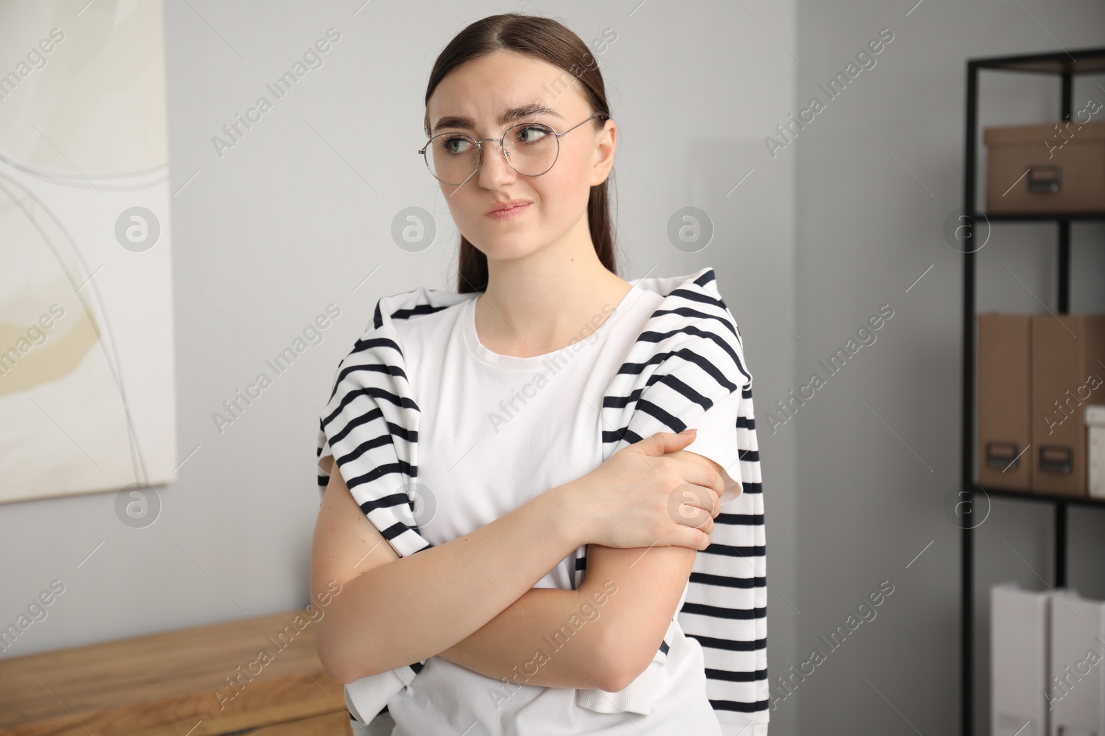 Photo of Portrait of embarrassed woman in glasses in office