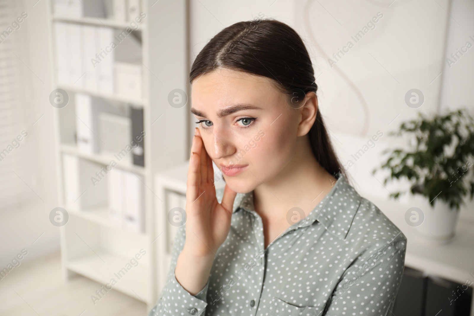 Photo of Embarrassed woman in office, space for text