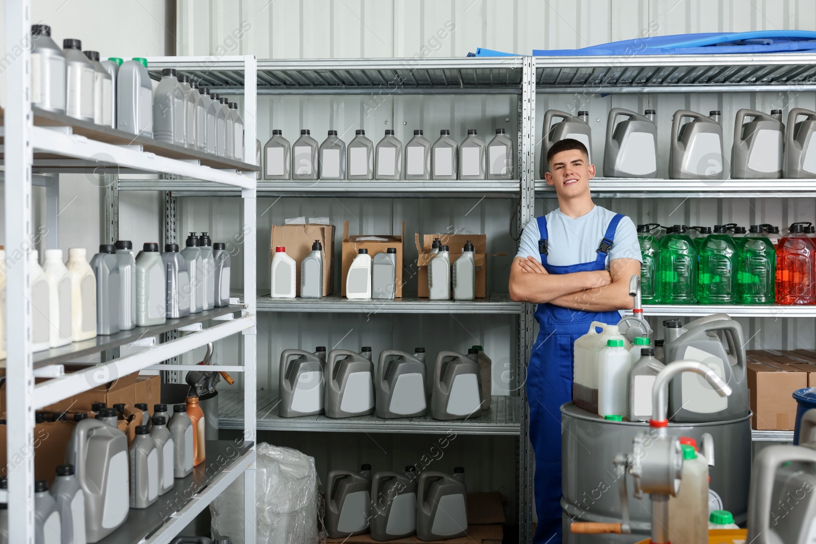 Photo of Smiling young man in auto store with different car products