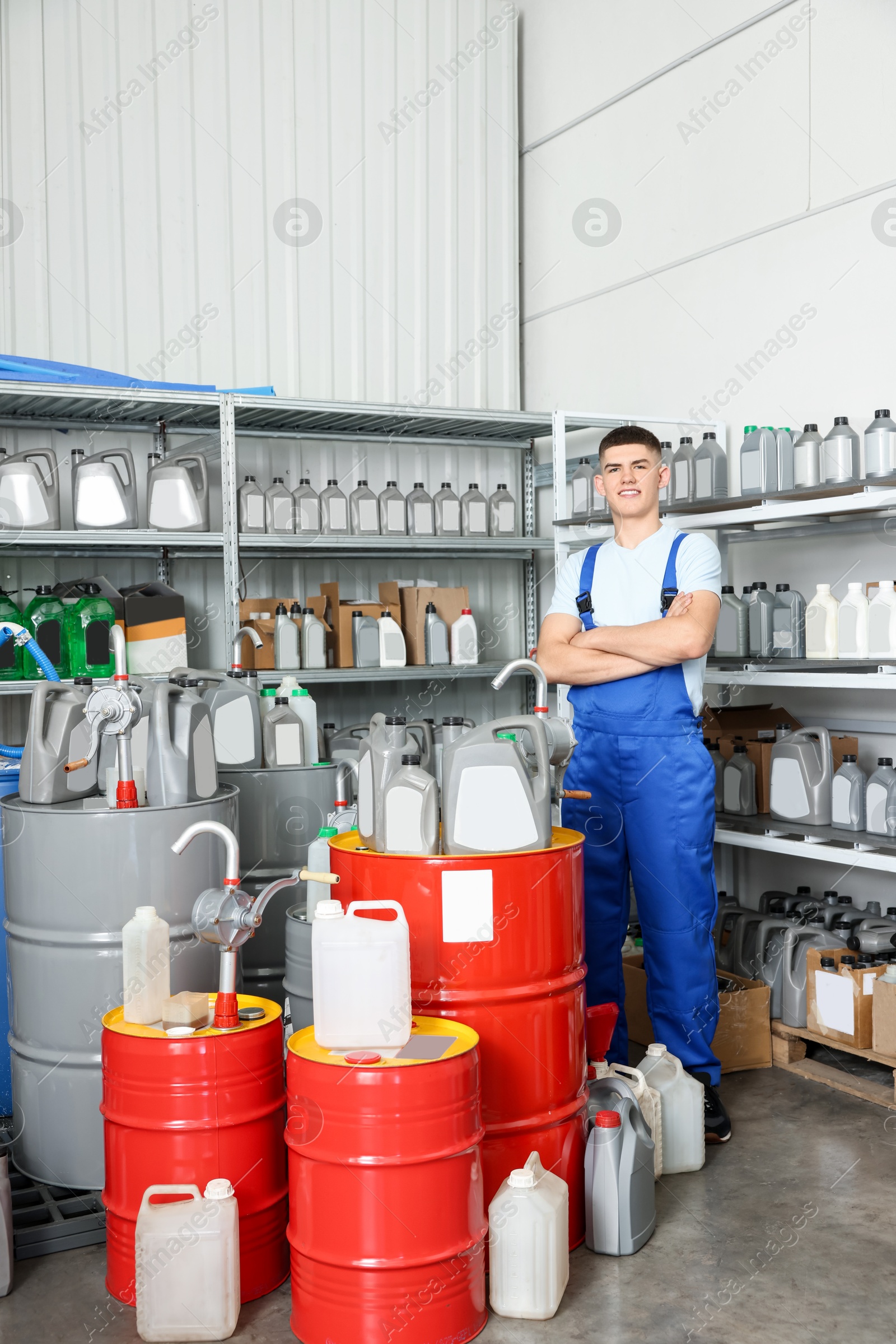 Photo of Smiling young man in auto store with different car products