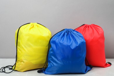 Photo of Three drawstring bags on light marble table