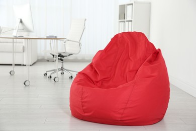 Photo of Red bean bag chair on floor in office
