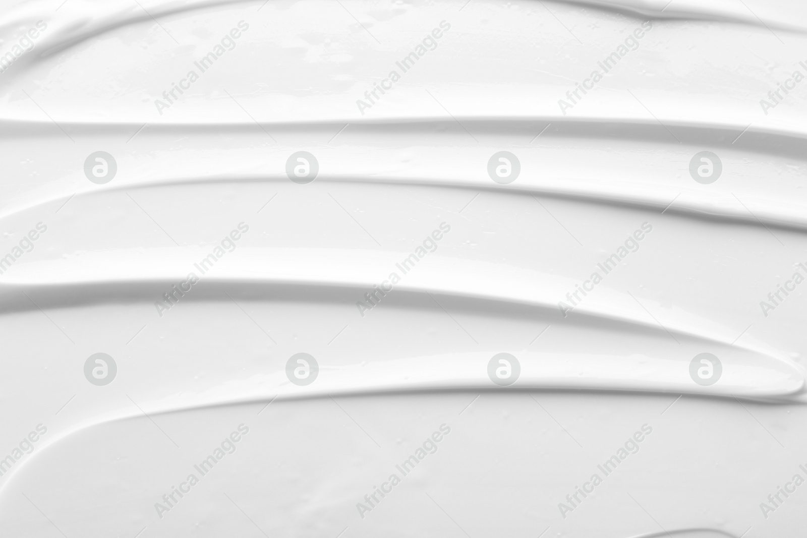 Photo of Texture of face care cream as background, top view