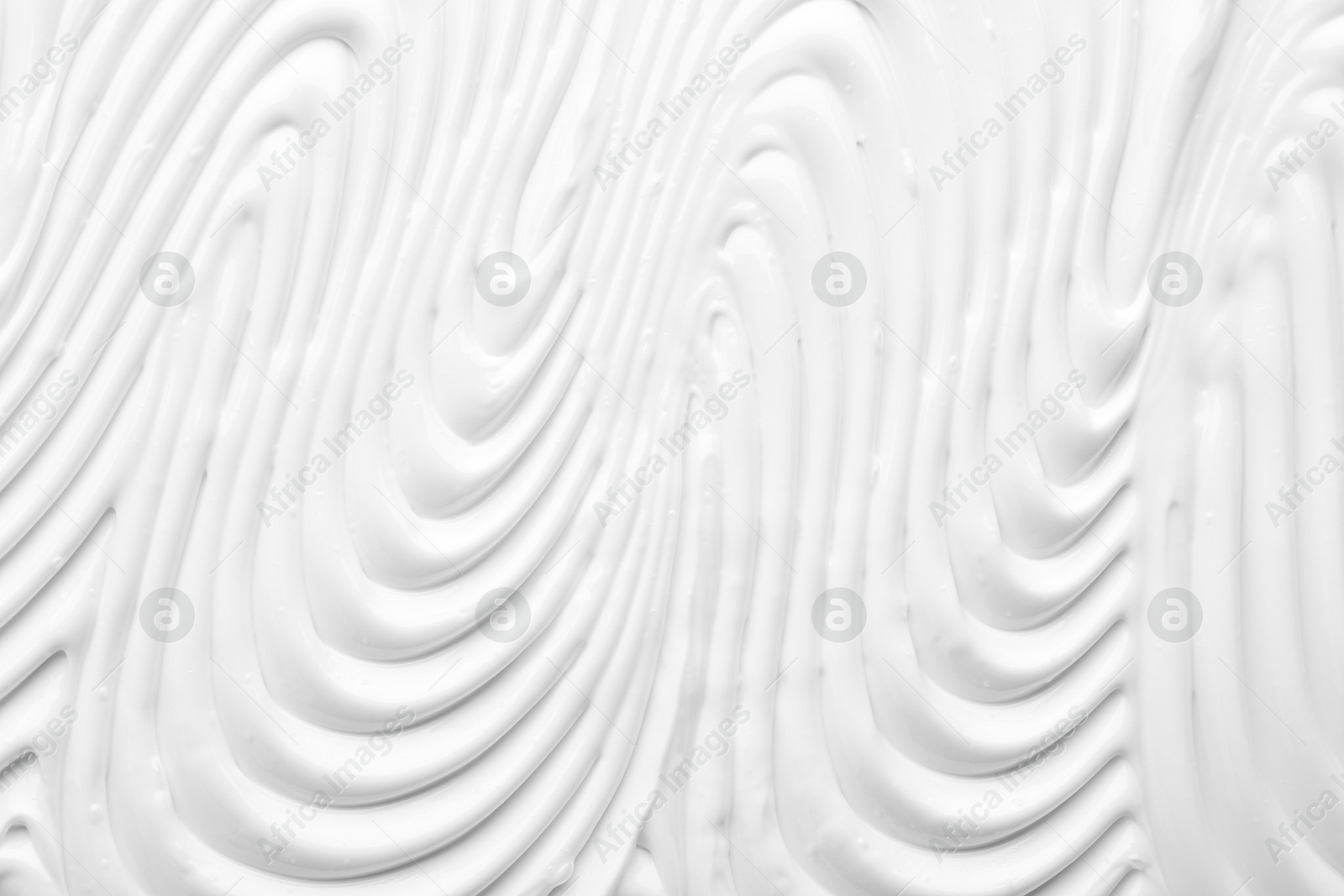 Photo of Texture of face care cream as background, top view