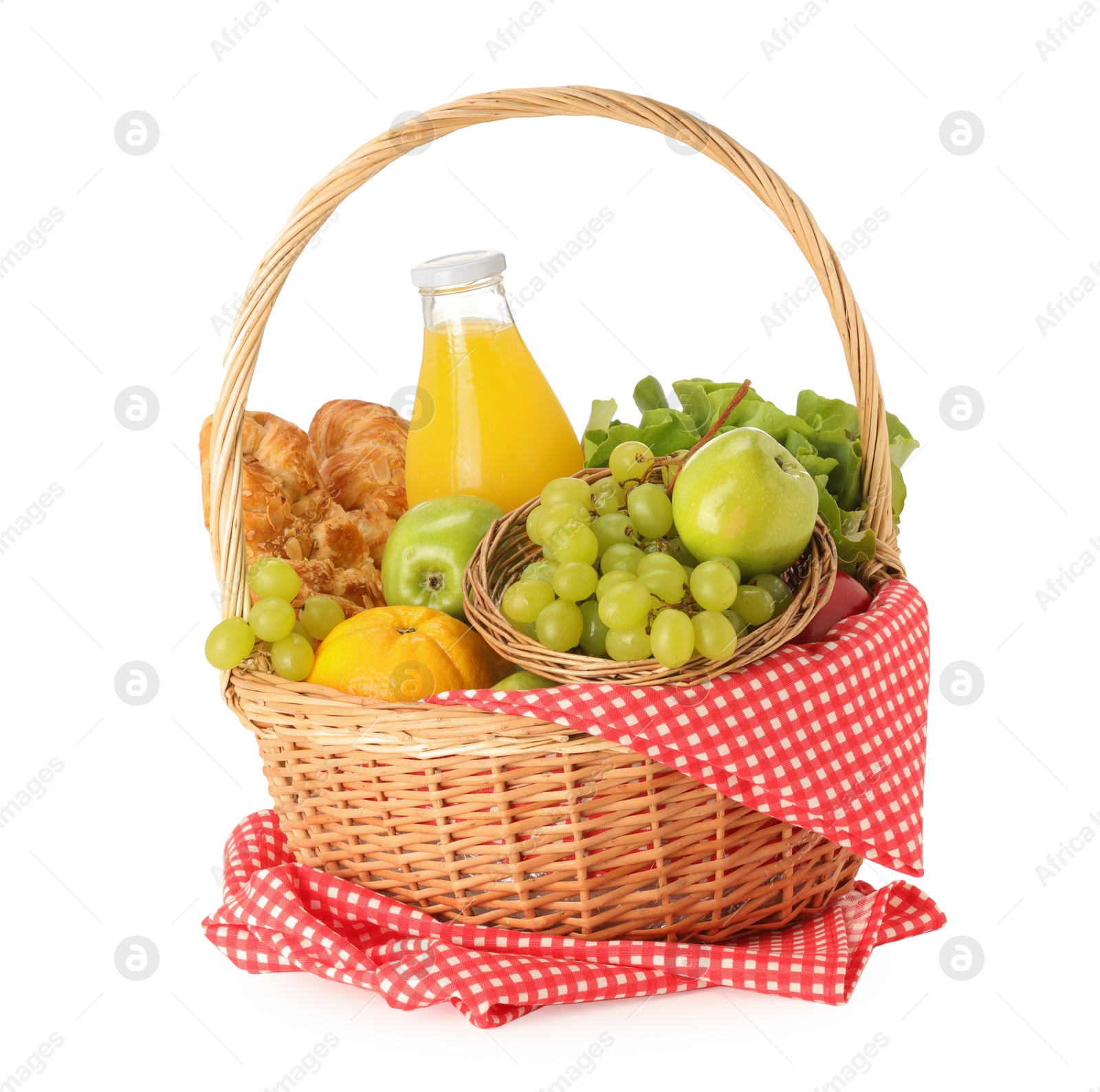 Photo of Picnic wicker basket with checkered napkin, food and juice isolated on white