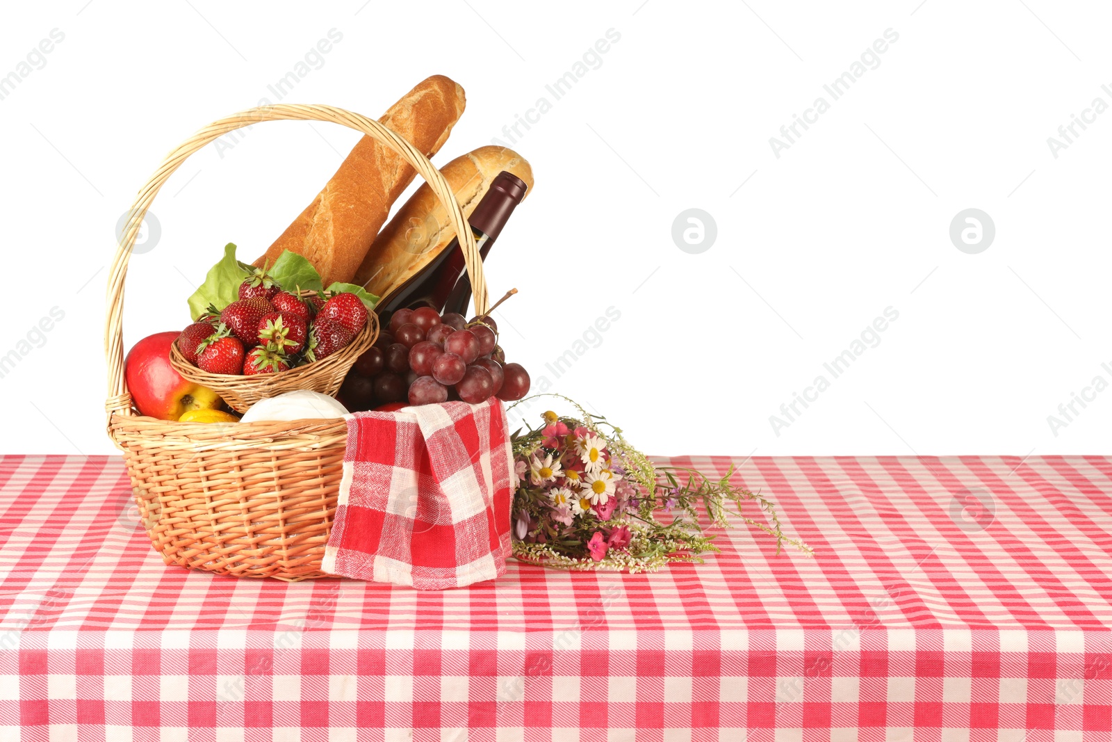 Photo of Picnic wicker basket with checkered napkin, food and bottle of wine on table against white background. Space for text