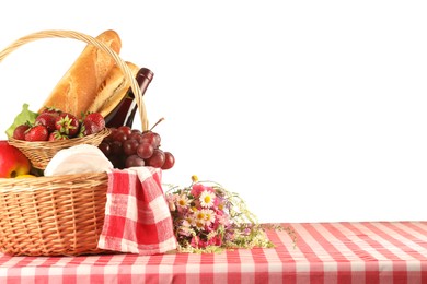 Photo of Picnic wicker basket with checkered napkin, food and bottle of wine on table against white background. Space for text