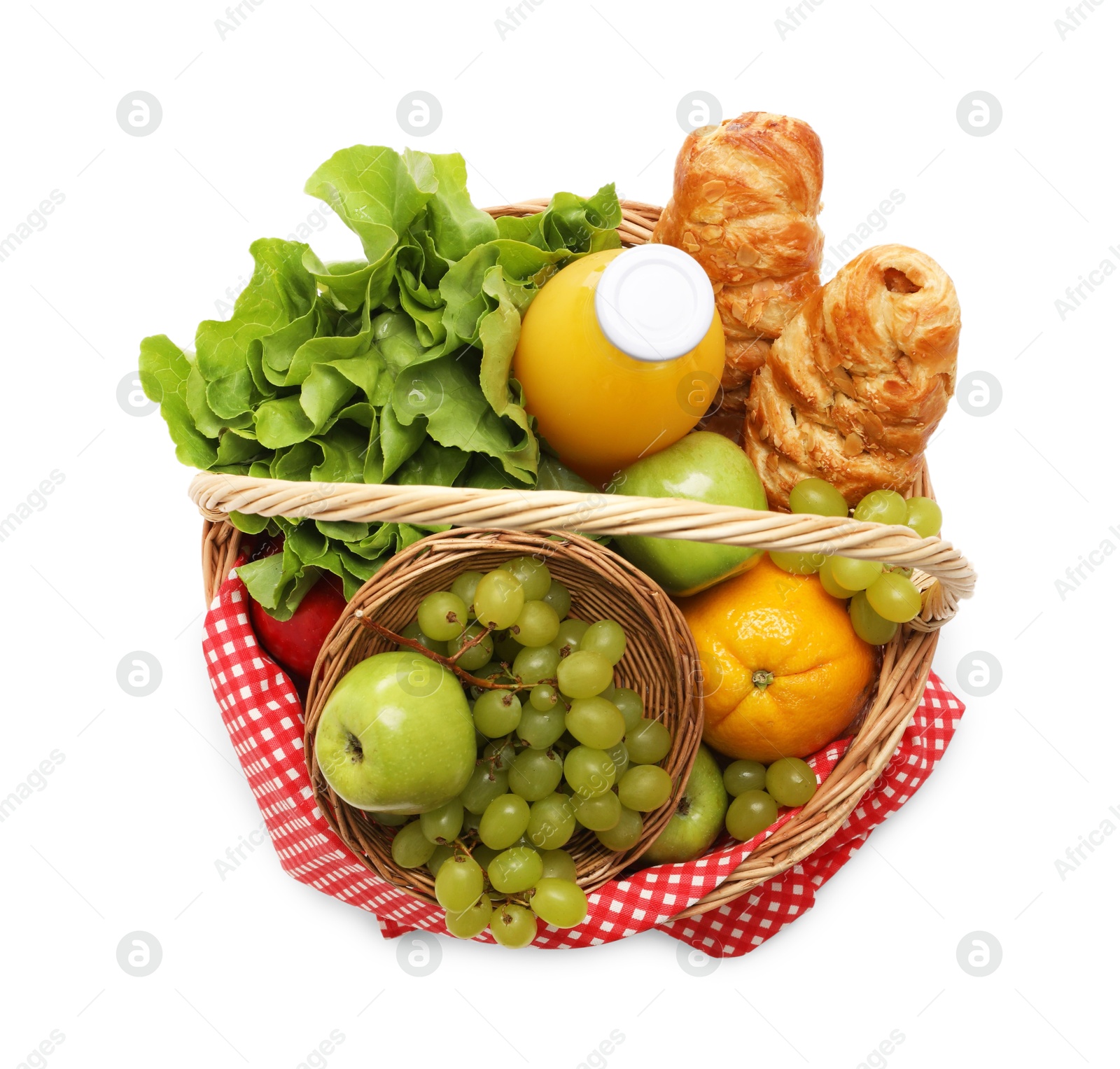 Photo of Picnic basket with checkered napkin, food and juice isolated on white, top view