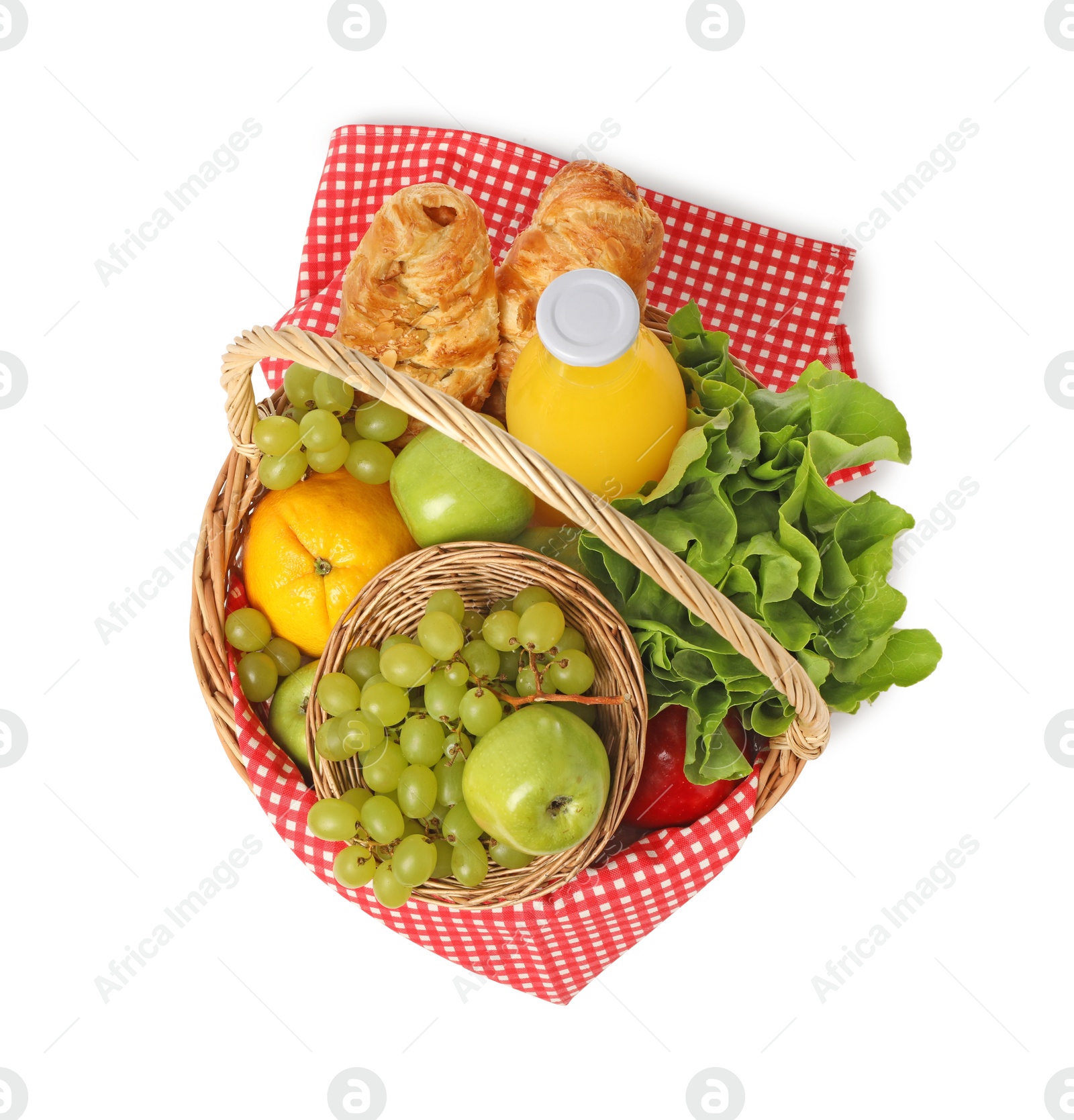 Photo of Picnic basket with checkered napkin, food and juice isolated on white, top view