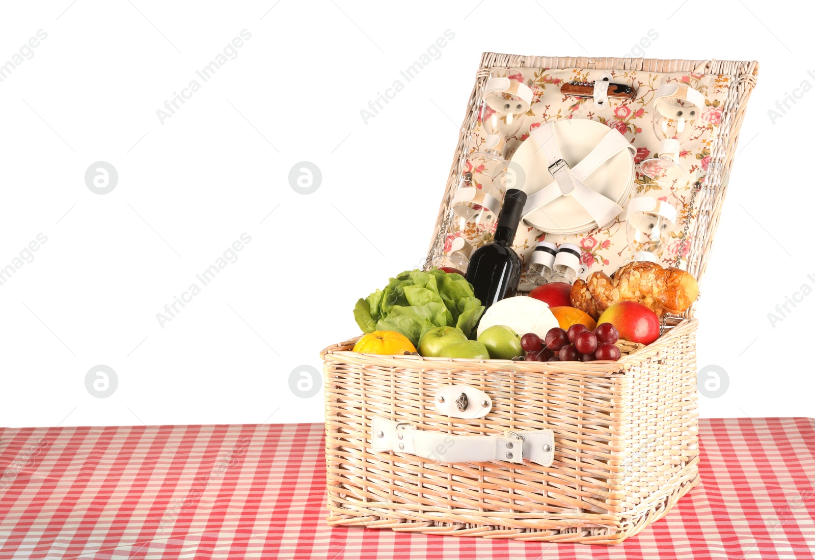 Photo of Picnic wicker basket with food, tableware and bottle of wine on table against white background. Space for text