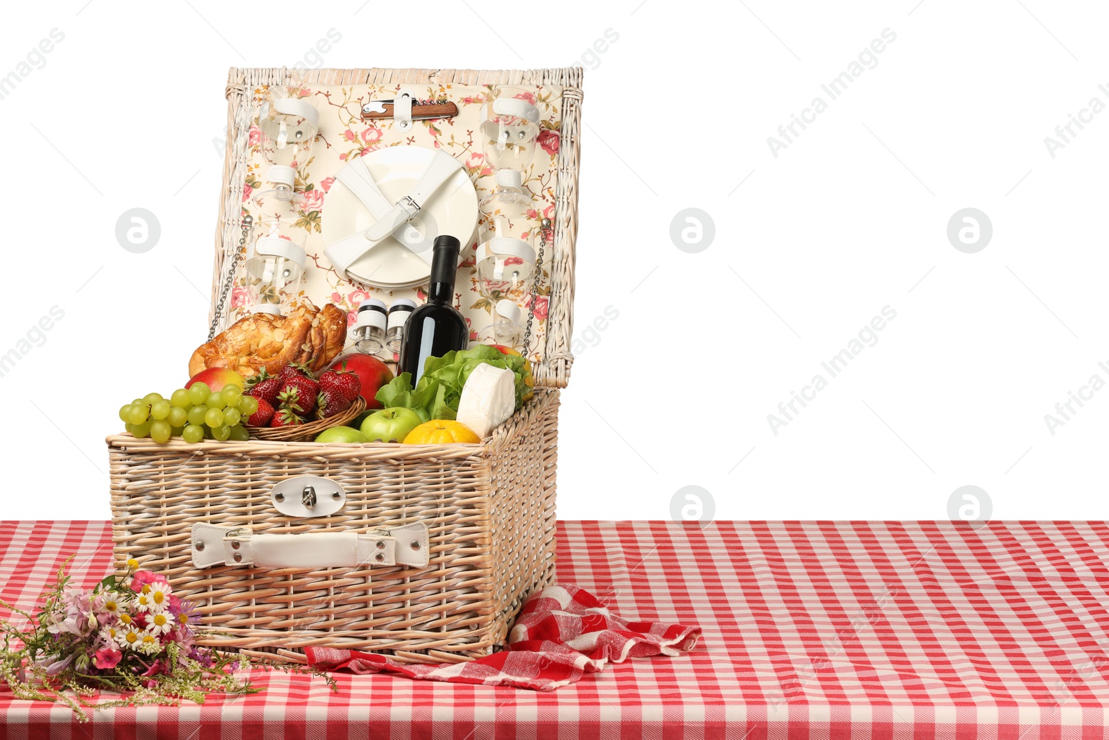 Photo of Picnic wicker basket with food, tableware and bottle of wine on table against white background. Space for text