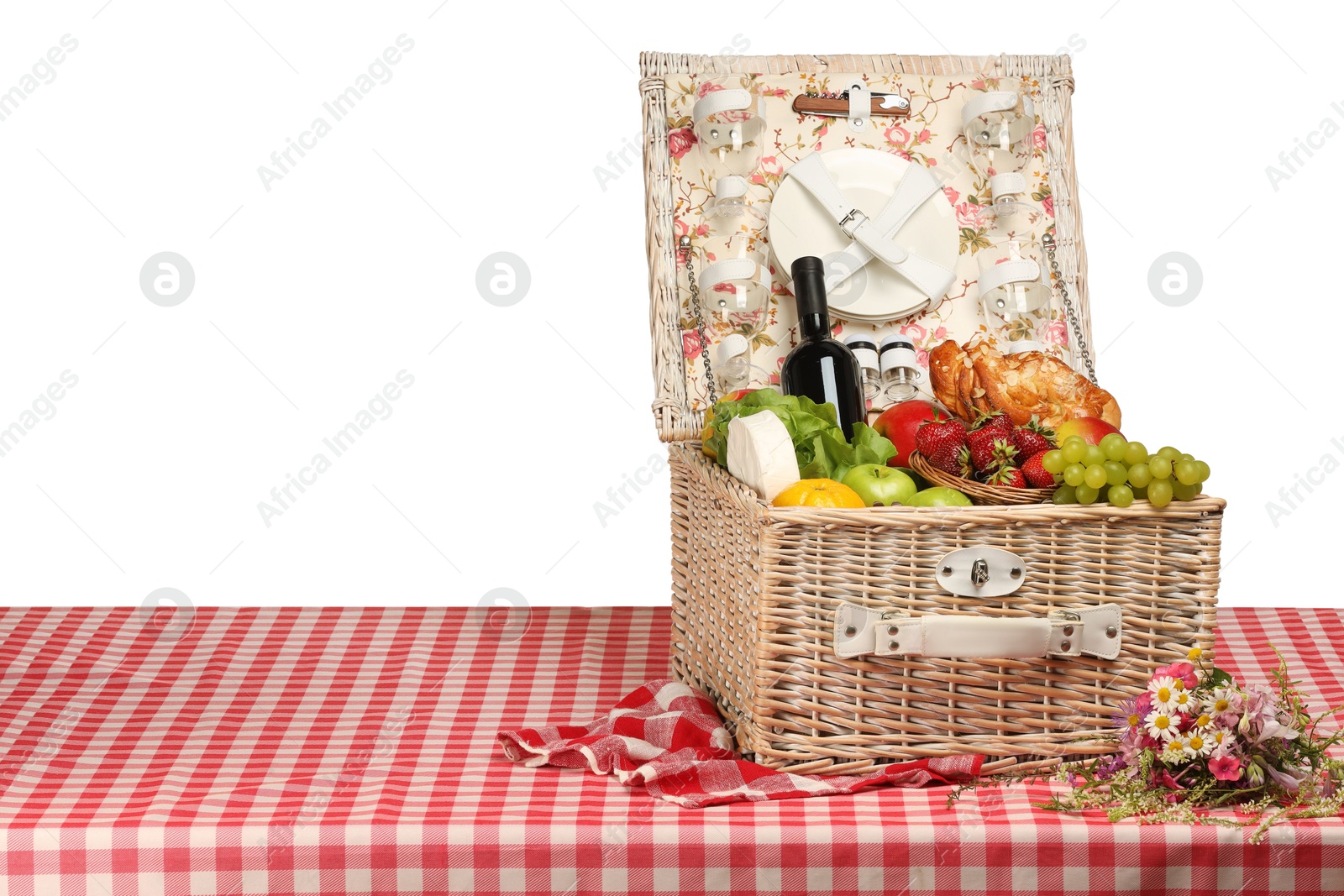 Photo of Picnic wicker basket with food, tableware and bottle of wine on table against white background. Space for text