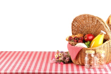 Photo of Picnic wicker basket with food, bottle of juice and flowers on table against white background. Space for text