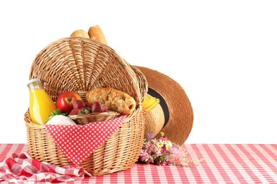 Photo of Picnic wicker basket with food, bottle of juice, napkin and hat on table against white background. Space for text