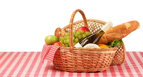 Picnic wicker basket with food, bottle of wine and napkin on table against white background. Space for text