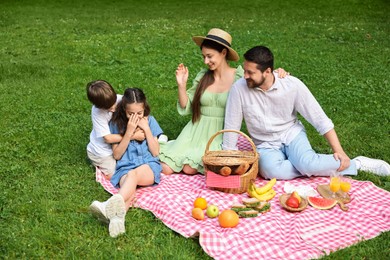Photo of Happy family having picnic together in park