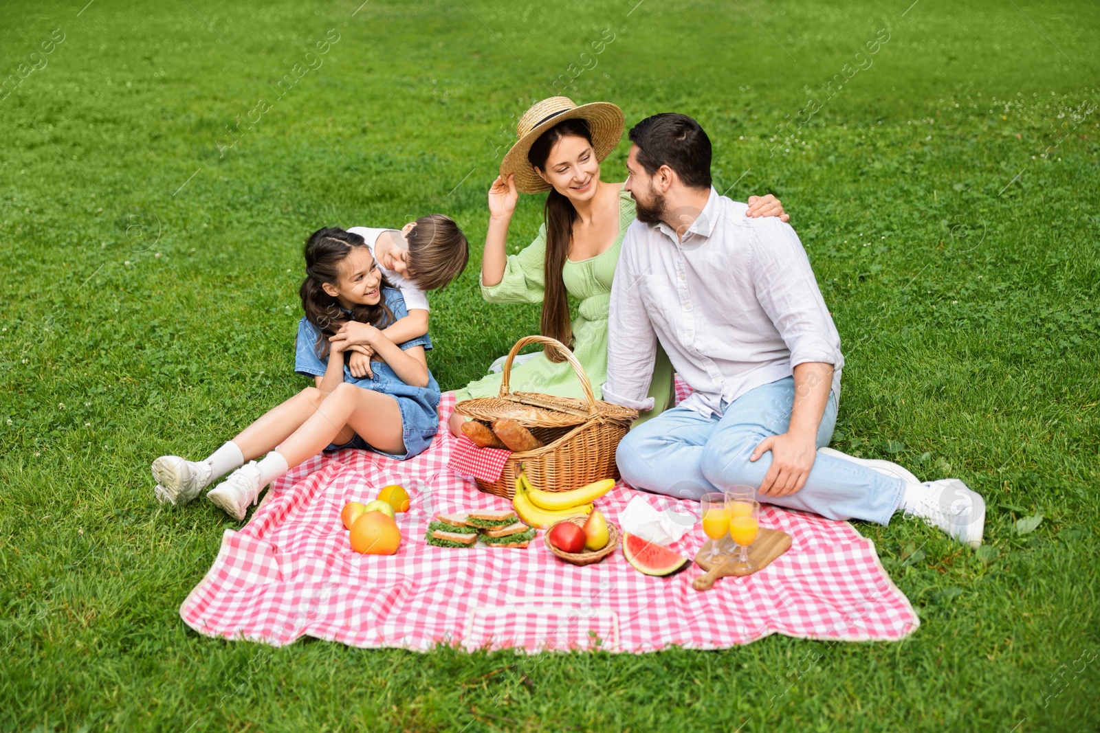 Photo of Happy family having picnic together in park