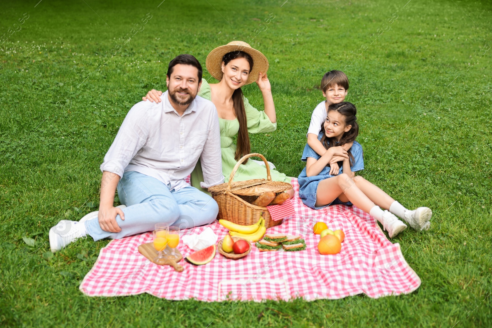 Photo of Happy family having picnic together in park