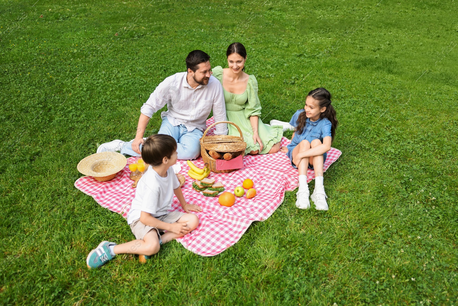 Photo of Happy family having picnic together in park