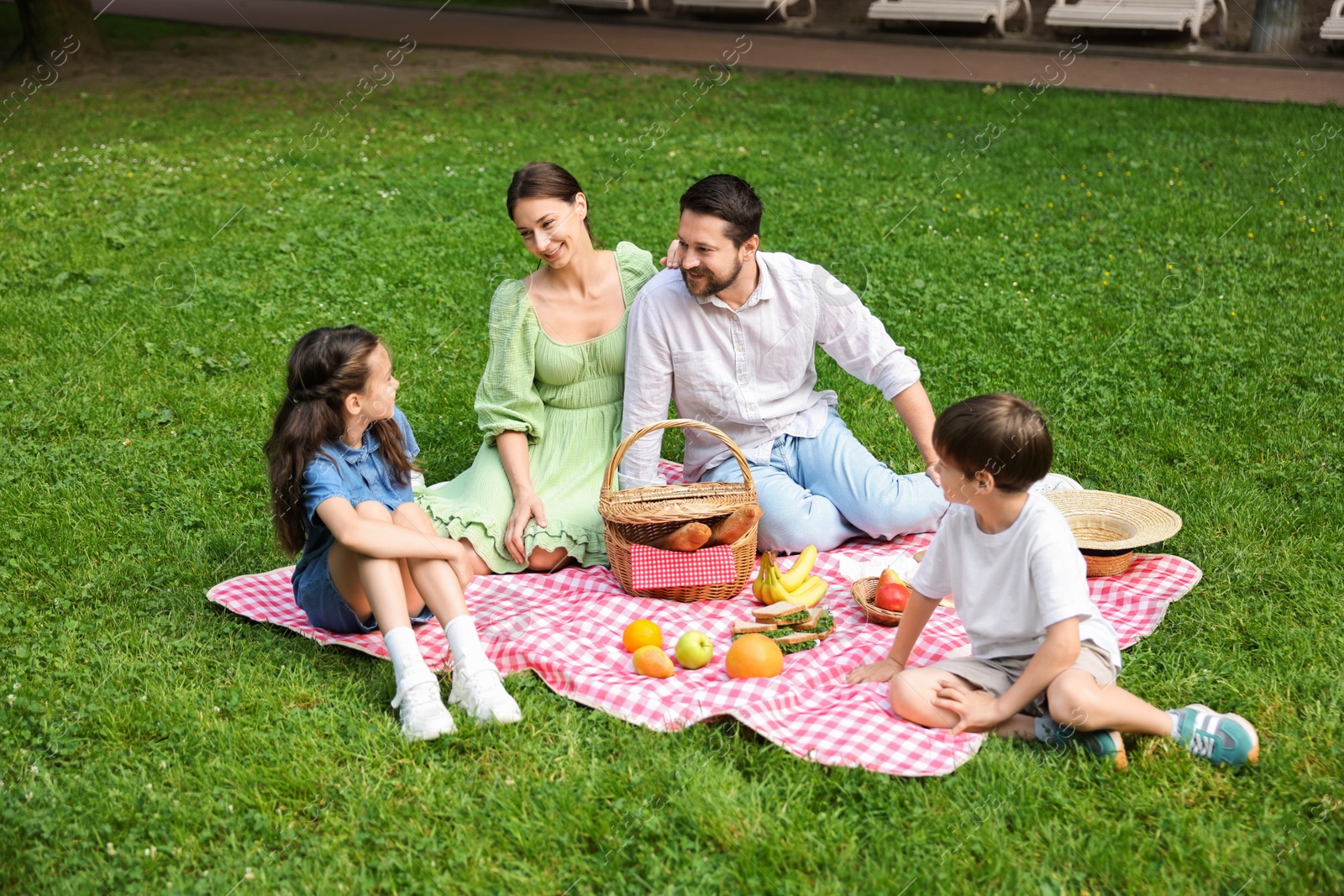 Photo of Happy family having picnic together in park