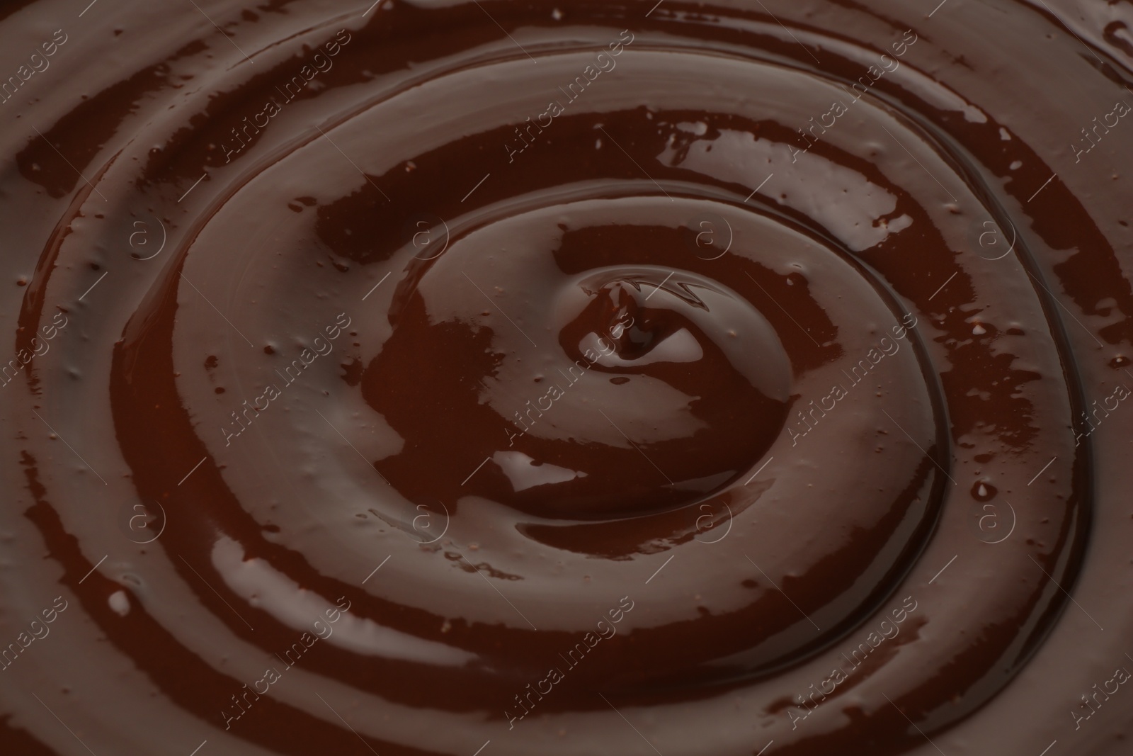 Photo of Tasty melted chocolate as background, closeup view