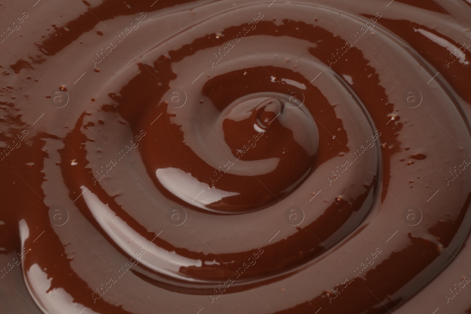 Photo of Tasty melted chocolate as background, closeup view