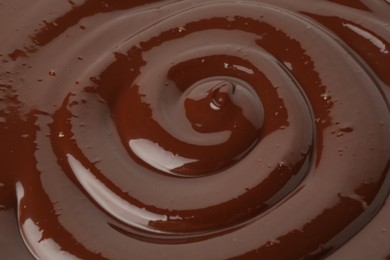 Photo of Tasty melted chocolate as background, closeup view