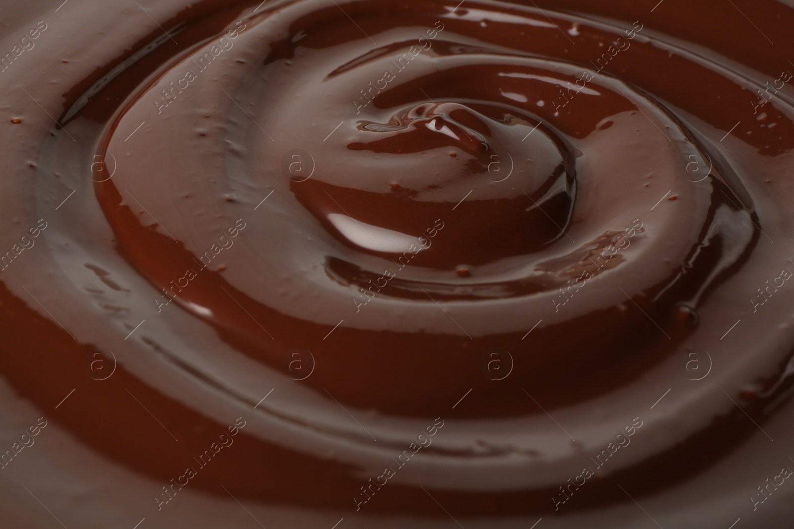 Photo of Tasty melted chocolate as background, closeup view