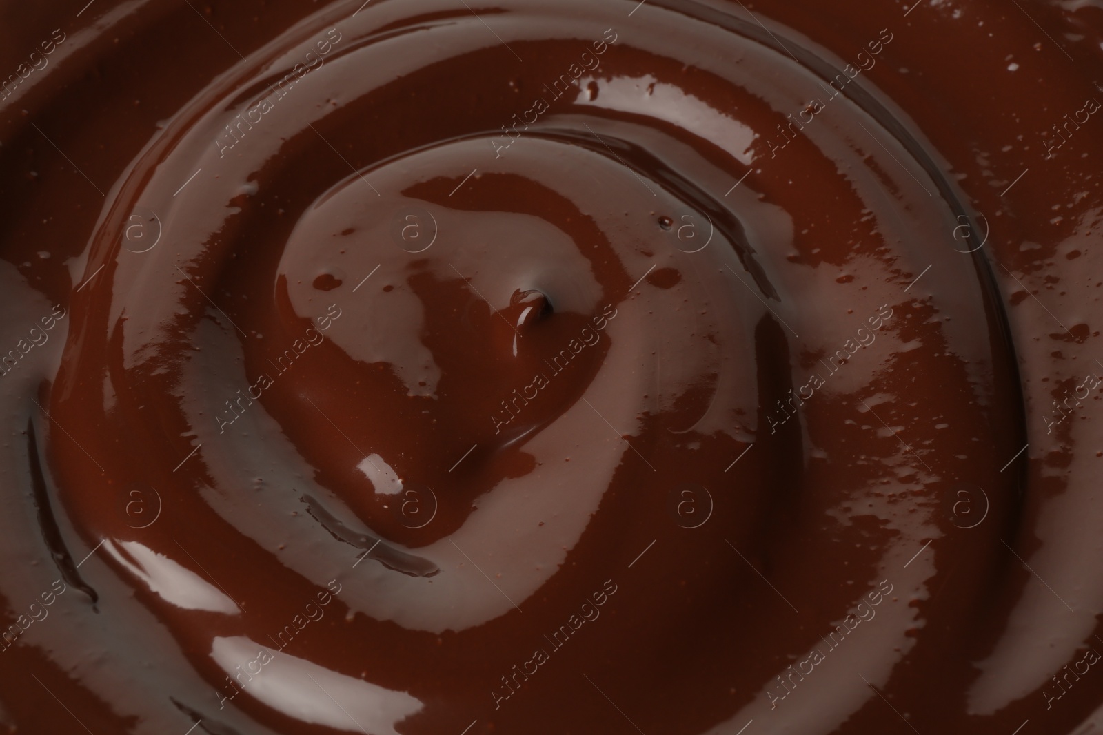 Photo of Tasty melted chocolate as background, closeup view