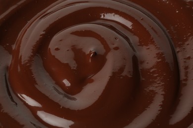 Photo of Tasty melted chocolate as background, closeup view