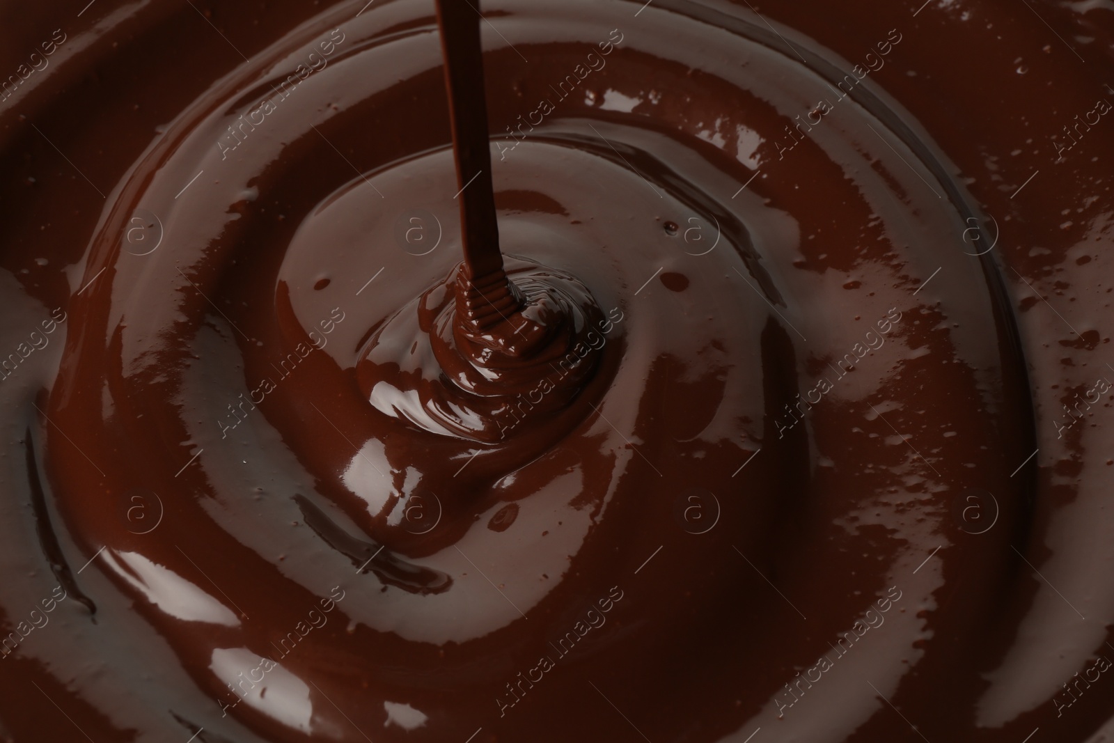 Photo of Closeup view of pouring delicious melted chocolate