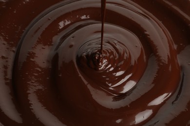 Photo of Closeup view of pouring delicious melted chocolate