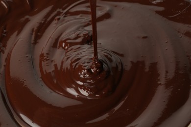 Photo of Closeup view of pouring delicious melted chocolate