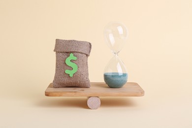 Photo of Equality concept. Burlap sack of money, hourglass with sand and seesaw scale on beige background