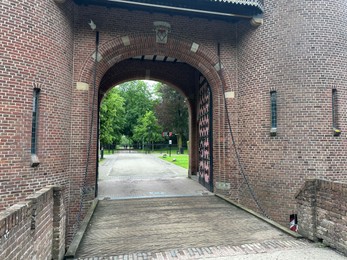 Photo of View of castle entrance and trees on spring day