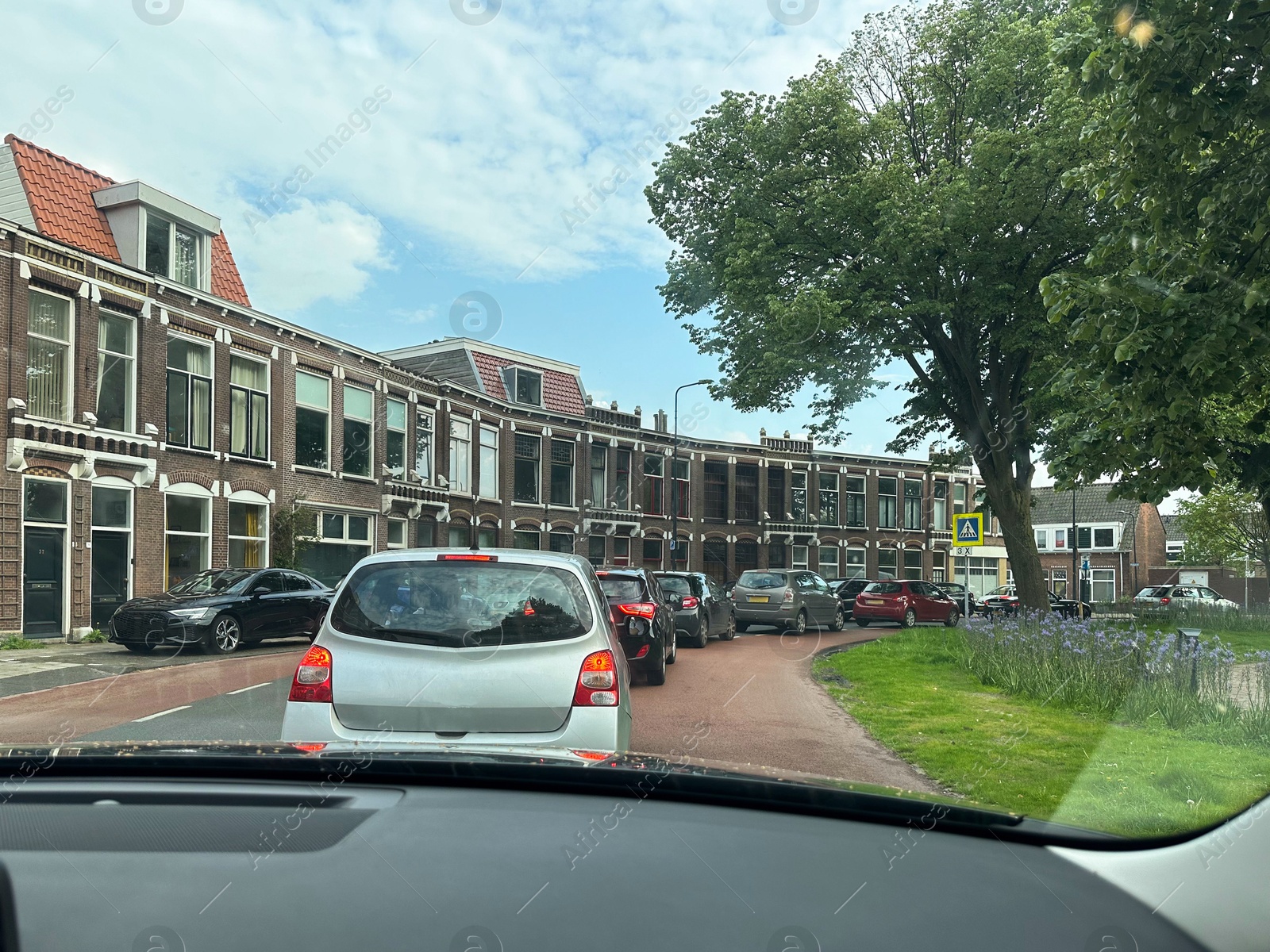 Photo of Cars in traffic jam on city street, view from driver's seat