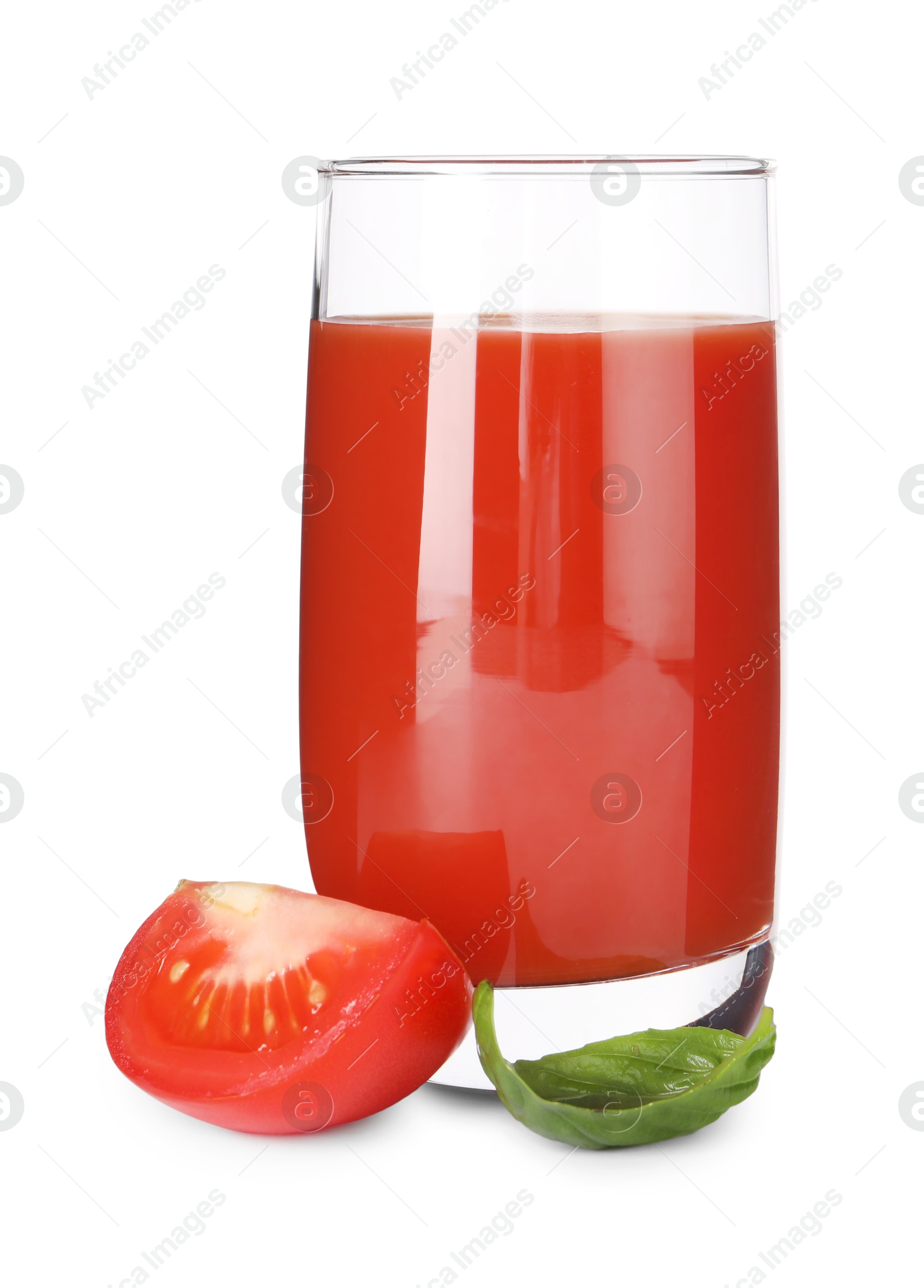 Photo of Tasty tomato juice in glass, basil leaf and fresh vegetable isolated on white