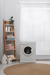 Washing machine, detergents, towels and shelving unit in laundry room