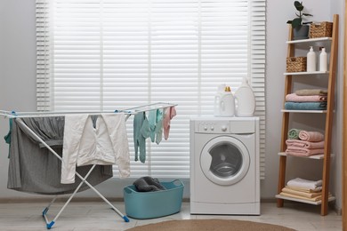 Washing machine, detergents, towels, basket and drying rack in laundry room