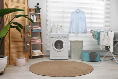 Washing machine, detergents, towels, baskets and drying rack in laundry room