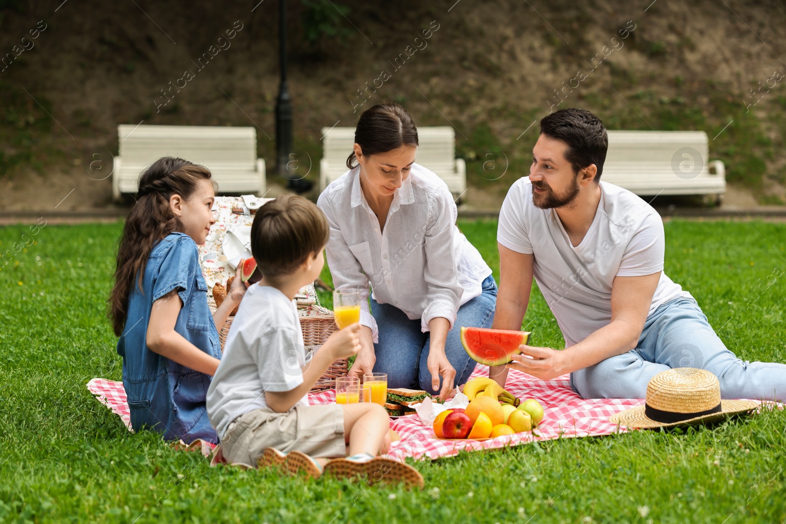 Photo of Lovely family having picnic together in park