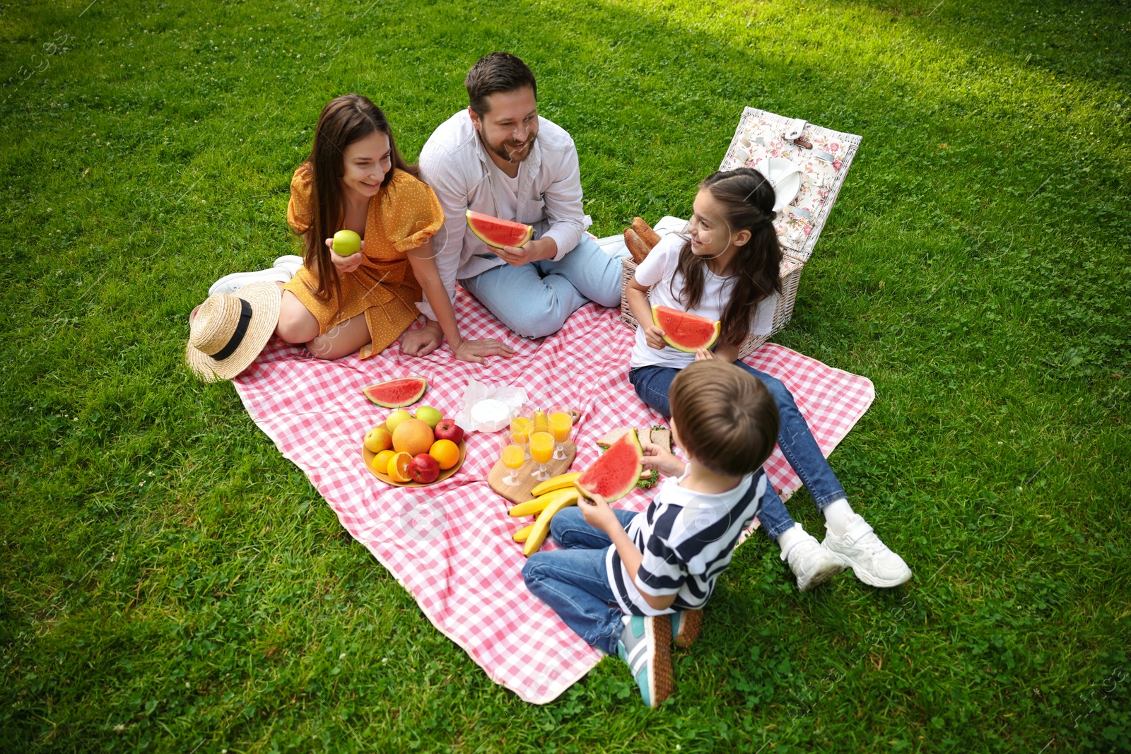 Photo of Happy family having picnic together in park