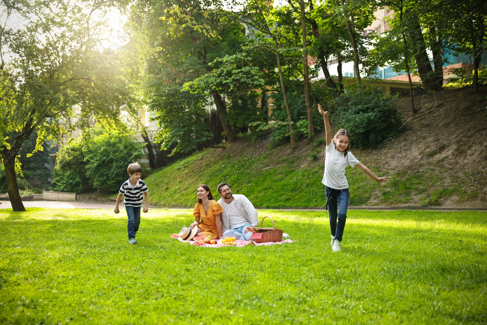 Photo of Happy children playing during family picnic outdoors