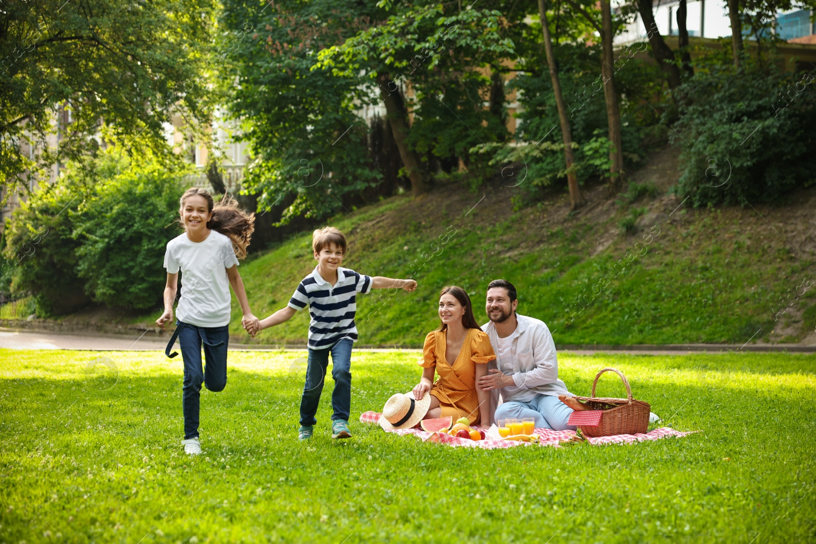 Photo of Happy children playing during family picnic outdoors